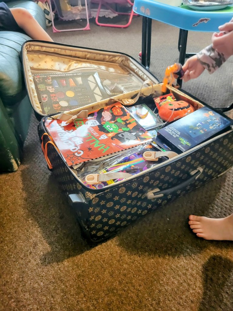 suitcase filled with halloween treasures